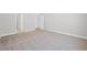 Spacious carpeted bedroom with ample natural light streaming through open doorway at 470 Village Ln, Fairburn, GA 30213