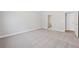 Spacious carpeted bedroom with bright white trim and a view into an adjoining bathroom at 470 Village Ln, Fairburn, GA 30213