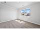 Bright bedroom with soft carpet, and a view of the neighborhood through the double windows at 470 Village Ln, Fairburn, GA 30213