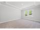 Bright bedroom featuring a tray ceiling and natural light from the double window at 470 Village Ln, Fairburn, GA 30213