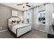 Cozy bedroom with neutral walls, two bright windows, and comfortable furnishings, creating a warm space at 470 Village Ln, Fairburn, GA 30213