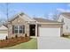 Charming one-story brick home with a two-car garage and well-manicured lawn at 470 Village Ln, Fairburn, GA 30213