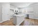 Modern kitchen featuring stainless steel appliances, island, and hardwood floors at 470 Village Ln, Fairburn, GA 30213