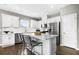 Bright kitchen featuring white cabinets, stainless steel appliances, a quartz island, and hardwood floors at 470 Village Ln, Fairburn, GA 30213