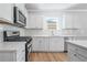 Well-equipped kitchen with stainless steel appliances and stone countertops at 470 Village Ln, Fairburn, GA 30213