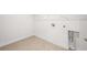 Small, efficient laundry room with tile flooring, ready for appliances and storage at 470 Village Ln, Fairburn, GA 30213