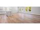 Bright living room with beautiful hardwood flooring, modern kitchen, and ample space at 470 Village Ln, Fairburn, GA 30213