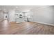 Open-concept living area with hardwood floors, modern kitchen, and ample space for entertaining at 470 Village Ln, Fairburn, GA 30213