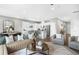 Open-concept living space with a kitchen featuring stainless steel appliances and a dining area with modern decor at 470 Village Ln, Fairburn, GA 30213