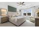 Elegant main bedroom with a tufted headboard, tray ceiling, and large windows for natural light at 470 Village Ln, Fairburn, GA 30213