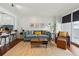 Sun-lit living room featuring a comfortable sofa, modern decor, and access to a balcony at 620 Peachtree Ne St # 403, Atlanta, GA 30308