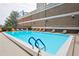Outdoor swimming pool with lounge chairs and tables on the deck at 620 Peachtree Ne St # 403, Atlanta, GA 30308