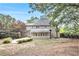 This home features a spacious backyard with a patio, mature trees, and manicured shrubbery at 1198 Larson Sw Ln, Marietta, GA 30064
