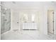 A spacious bathroom with marble floors, a glass shower, and a double sink vanity at 1198 Larson Sw Ln, Marietta, GA 30064