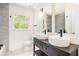 Bathroom featuring double sinks, modern fixtures, and gray tile at 1198 Larson Sw Ln, Marietta, GA 30064