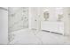 A bright bathroom featuring marble floors, a glass shower, and a double sink vanity at 1198 Larson Sw Ln, Marietta, GA 30064