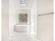 A bright bathroom with marble floors featuring a soaking tub and a skylight at 1198 Larson Sw Ln, Marietta, GA 30064