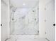 A modern all-white bathroom showcasing a glass-enclosed walk-in shower with dual shower heads at 1198 Larson Sw Ln, Marietta, GA 30064