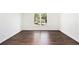 Bright, empty bedroom featuring hardwood floors, a large window and ample natural light at 1198 Larson Sw Ln, Marietta, GA 30064