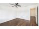 This bedroom features a ceiling fan, dark hardwood floors, and a view to an ensuite at 1198 Larson Sw Ln, Marietta, GA 30064