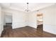 Formal dining room with modern light fixture, hardwood floors, and detailed molding for elegant entertaining at 1198 Larson Sw Ln, Marietta, GA 30064