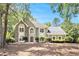 Charming home featuring stone accents, arched windows, manicured landscaping, and a well-maintained lawn at 1198 Larson Sw Ln, Marietta, GA 30064
