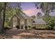 This home features a manicured lawn, mature trees, and a beautiful stone and siding facade at 1198 Larson Sw Ln, Marietta, GA 30064