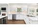 Gourmet kitchen features white cabinetry, stainless steel appliances, and hardwood floors, perfect for cooking at 1198 Larson Sw Ln, Marietta, GA 30064