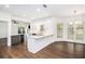 Spacious kitchen featuring an island with bar seating, quartz counters, and hardwood floors at 1198 Larson Sw Ln, Marietta, GA 30064