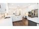 Modern kitchen with white cabinets, stainless steel appliances, quartz countertops, and hardwood flooring at 1198 Larson Sw Ln, Marietta, GA 30064