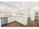 Bright kitchen boasts white cabinetry, quartz countertops, and modern appliances, creating an open space at 1198 Larson Sw Ln, Marietta, GA 30064