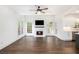 Bright living room with a cozy fireplace, modern ceiling fan, hardwood flooring, and an open concept design at 1198 Larson Sw Ln, Marietta, GA 30064