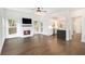 Open concept living room with hardwood floors, fireplace, TV and view of the modern kitchen at 1198 Larson Sw Ln, Marietta, GA 30064