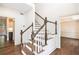 Elegant staircase features white railings, wood steps, and hardwood flooring, seamlessly connecting levels at 1198 Larson Sw Ln, Marietta, GA 30064