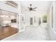 Bright sunroom featuring tile floors, multiple windows and glass doors leading to the modern kitchen at 1198 Larson Sw Ln, Marietta, GA 30064