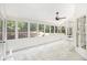 Bright sunroom with tile flooring, a ceiling fan, and windows overlooking the backyard at 1198 Larson Sw Ln, Marietta, GA 30064