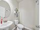 Neat powder room featuring a pedestal sink, toilet, and modern fixtures at 20 Tarpley Way, Covington, GA 30016
