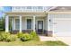 Charming home entrance with white pillars, stone accents, and a welcoming front door at 20 Tarpley Way, Covington, GA 30016