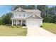 Charming two-story home with a well-manicured lawn and attached two-car garage at 20 Tarpley Way, Covington, GA 30016