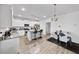 Open-concept kitchen features a central island, granite countertops, stainless steel appliances and a connecting dining area at 20 Tarpley Way, Covington, GA 30016