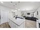 Open kitchen with granite island flows into a living area, perfect for gatherings at 20 Tarpley Way, Covington, GA 30016