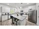 Bright kitchen featuring granite counters, stainless steel appliances, white cabinets, and a central island at 20 Tarpley Way, Covington, GA 30016