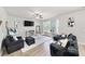 Stylish living room featuring modern furniture, a fireplace, and hardwood floors at 20 Tarpley Way, Covington, GA 30016