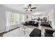 Spacious living room with a ceiling fan, hardwood floors, and a view into the dining area at 20 Tarpley Way, Covington, GA 30016