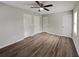 Bright bedroom featuring hardwood floors, ceiling fan, and multiple closets for ample storage at 2550 Stoney Brook Ne Ln, Marietta, GA 30062
