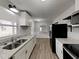 Updated kitchen features granite countertops, white cabinetry, and stainless steel appliances at 2550 Stoney Brook Ne Ln, Marietta, GA 30062