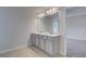 Bathroom with double sink vanity, gray cabinetry, and large mirror with modern lighting at 305 Heavenly Hollow Pl, Mcdonough, GA 30253