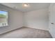 Bedroom features neutral walls and carpet with natural light at 305 Heavenly Hollow Pl, Mcdonough, GA 30253