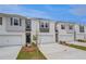 Newly built townhouses featuring attached garages and individual driveways at 305 Heavenly Hollow Pl, Mcdonough, GA 30253