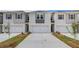 Modern townhomes boasting individual driveways and white painted brick at 305 Heavenly Hollow Pl, Mcdonough, GA 30253